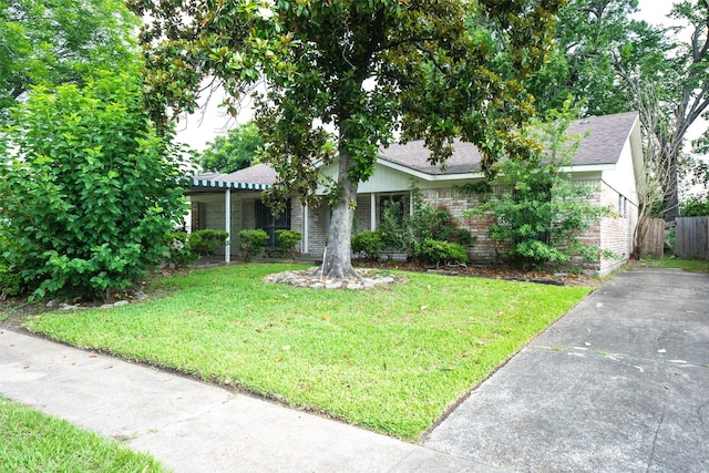 7613 Parker Rd, Houston, TX 77016 - view of property hidden behind natural elements with roof with shingles and brick siding