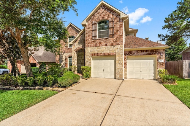 162 E Concord Valley Cir, The Woodlands, TX 77382 - traditional-style house with concrete driveway, stone siding, a shingled roof, and brick siding