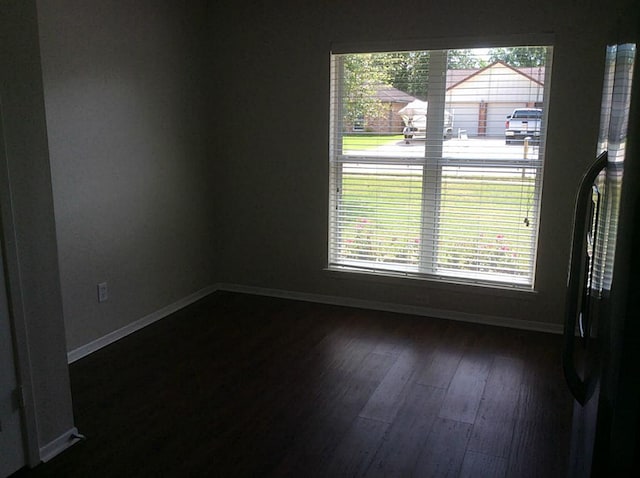 5 Lazybrook St, Angleton, TX 77515 - spare room with baseboards and dark wood-type flooring