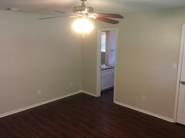 5 Lazybrook St, Angleton, TX 77515 - empty room featuring a ceiling fan, dark wood-style floors, and baseboards