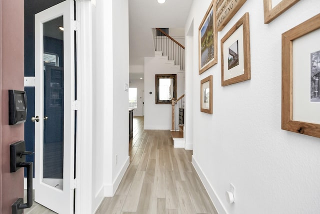 18511 Adventurous Way, Cypress, TX 77433 - hallway featuring stairs, light wood finished floors, and baseboards