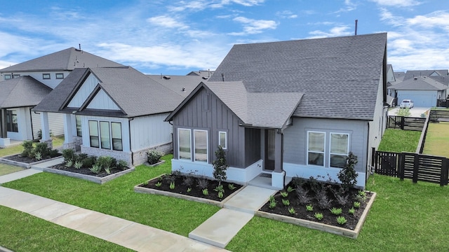 18511 Adventurous Way, Cypress, TX 77433 - view of front of home featuring board and batten siding, a sunroom, a vegetable garden, and a shingled roof