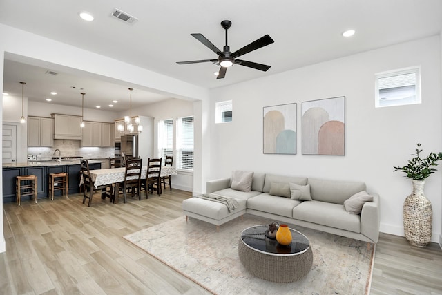18511 Adventurous Way, Cypress, TX 77433 - living room with light wood-style flooring, recessed lighting, a chandelier, a ceiling fan, and baseboards