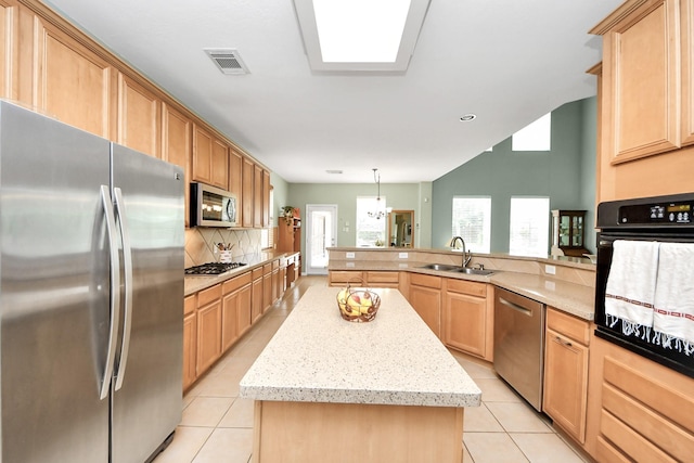 11401 Starlight Bay St, Pearland, TX 77584 - kitchen with appliances with stainless steel finishes, a sink, light tile patterned floors, and a kitchen island