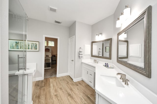 11401 Starlight Bay St, Pearland, TX 77584 - bathroom featuring wood finished floors, double vanity, and baseboards