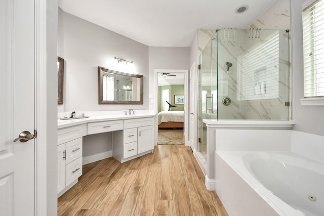 11401 Starlight Bay St, Pearland, TX 77584 - full bath featuring a marble finish shower, a garden tub, vanity, wood finished floors, and a ceiling fan