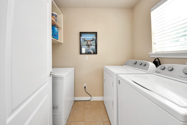 11401 Starlight Bay St, Pearland, TX 77584 - laundry area with washer and clothes dryer, light tile patterned floors, and baseboards
