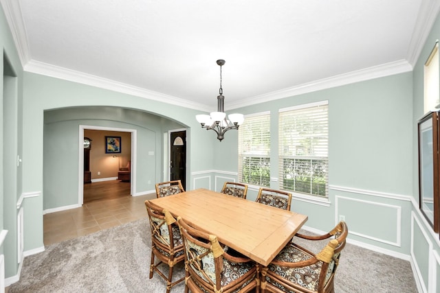 11401 Starlight Bay St, Pearland, TX 77584 - tiled dining room with arched walkways, a chandelier, and crown molding