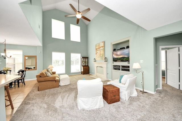 11401 Starlight Bay St, Pearland, TX 77584 - living room with a ceiling fan, a chandelier, high vaulted ceiling, baseboards, and light tile patterned floors