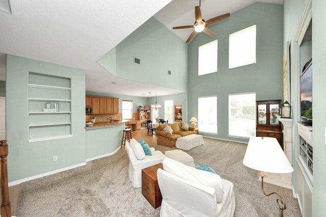 11401 Starlight Bay St, Pearland, TX 77584 - living area with light carpet, a ceiling fan, built in features, and baseboards