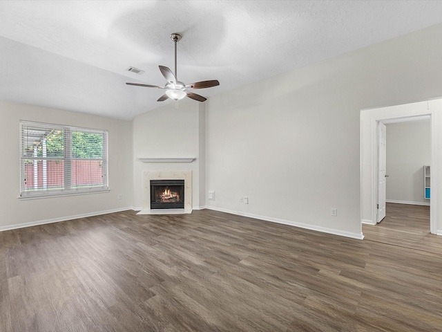 27097 Crown Chase Dr, Kingwood, TX 77339 - unfurnished living room featuring a ceiling fan, a fireplace with flush hearth, dark wood finished floors, baseboards, and vaulted ceiling