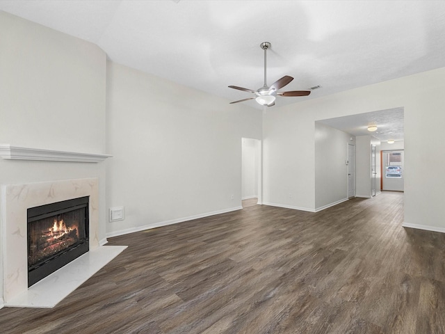27097 Crown Chase Dr, Kingwood, TX 77339 - unfurnished living room featuring a ceiling fan, dark wood finished floors, a premium fireplace, and baseboards