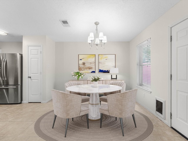 27097 Crown Chase Dr, Kingwood, TX 77339 - dining space with a chandelier, light tile patterned flooring, and baseboards