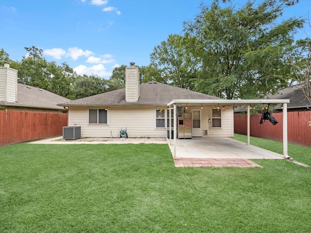 27097 Crown Chase Dr, Kingwood, TX 77339 - back of property with cooling unit, a patio area, a chimney, and roof with shingles
