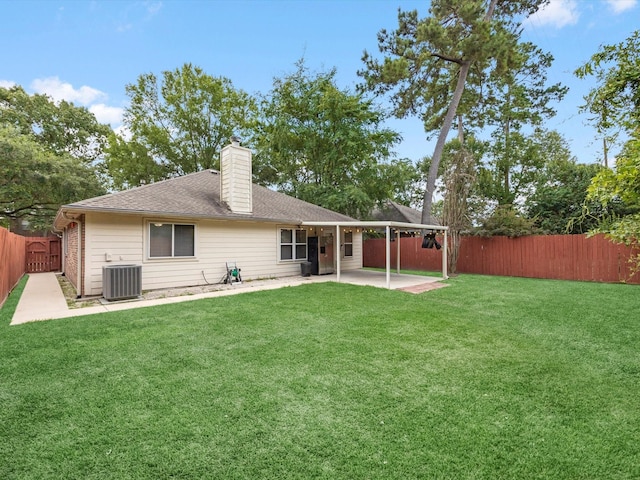 27097 Crown Chase Dr, Kingwood, TX 77339 - rear view of property featuring a patio area, a chimney, cooling unit, and a shingled roof