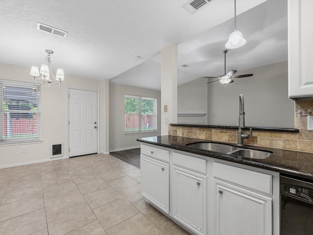 27097 Crown Chase Dr, Kingwood, TX 77339 - kitchen featuring black dishwasher, a sink, backsplash, baseboards, and white cabinets