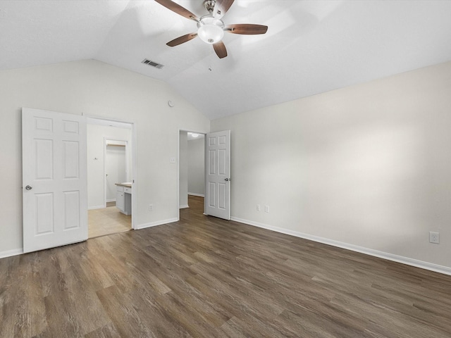 27097 Crown Chase Dr, Kingwood, TX 77339 - unfurnished bedroom with dark wood-type flooring, lofted ceiling, and baseboards