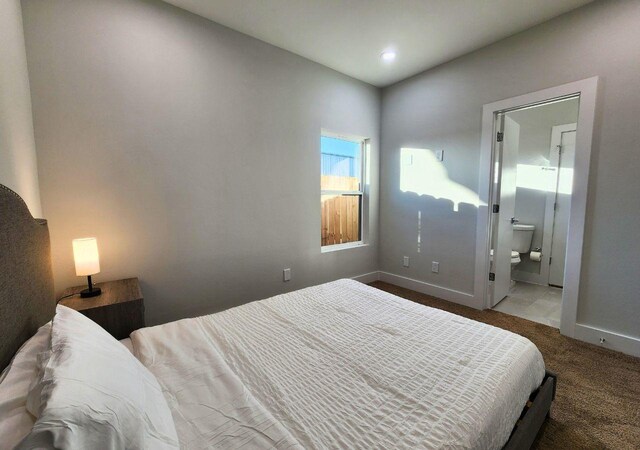 615 Northew St Unit J, Houston, TX 77091 - bedroom with carpet floors, baseboards, and ensuite bathroom