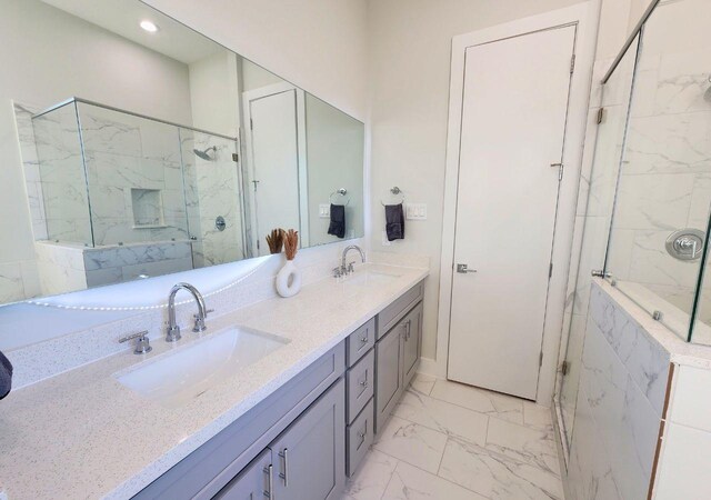 615 Northew St Unit J, Houston, TX 77091 - bathroom with marble look tile flooring, a marble finish shower, double vanity, and recessed lighting