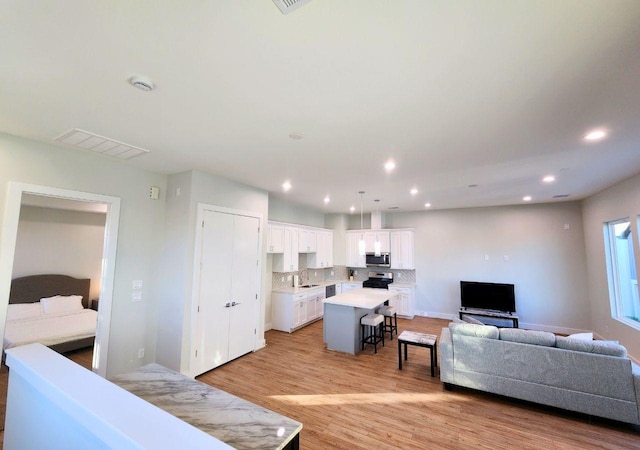 615 Northew St Unit J, Houston, TX 77091 - living room with light wood-style floors and recessed lighting