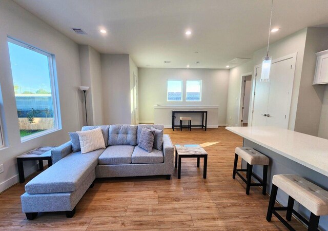 615 Northew St Unit J, Houston, TX 77091 - living room with light wood-style floors, recessed lighting, and baseboards