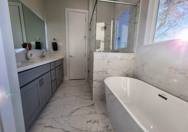 615 Northew St Unit J, Houston, TX 77091 - bathroom with a freestanding tub, double vanity, marble finish floors, a marble finish shower, and tile walls
