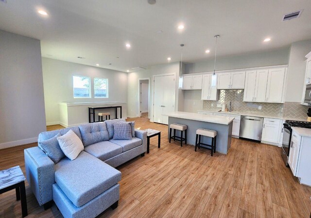 615 Northew St Unit J, Houston, TX 77091 - living area with light wood-style flooring, recessed lighting, and baseboards