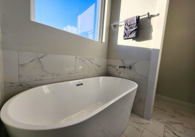 615 Northew St Unit J, Houston, TX 77091 - bathroom with marble look tiles, a soaking tub, and tile walls