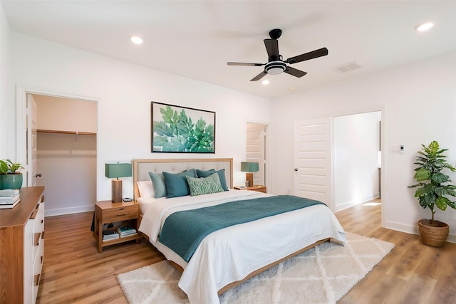 601 S Carroll St, La Porte, TX 77571 - bedroom with a closet, light wood-style flooring, a spacious closet, recessed lighting, and baseboards