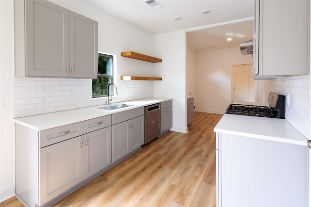 601 S Carroll St, La Porte, TX 77571 - kitchen with dishwasher, gas range, a sink, decorative backsplash, and gray cabinets