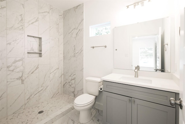 601 S Carroll St, La Porte, TX 77571 - full bathroom with vanity, toilet, a tile shower, and marble finish flooring