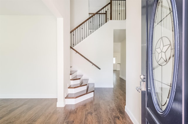 10618 Bassoon Dr, Houston, TX 77025 - entrance foyer featuring wood finished floors, stairs, baseboards, and a towering ceiling