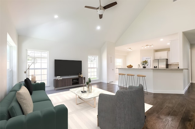 10618 Bassoon Dr, Houston, TX 77025 - living room featuring a ceiling fan, high vaulted ceiling, wood finished floors, recessed lighting, and baseboards