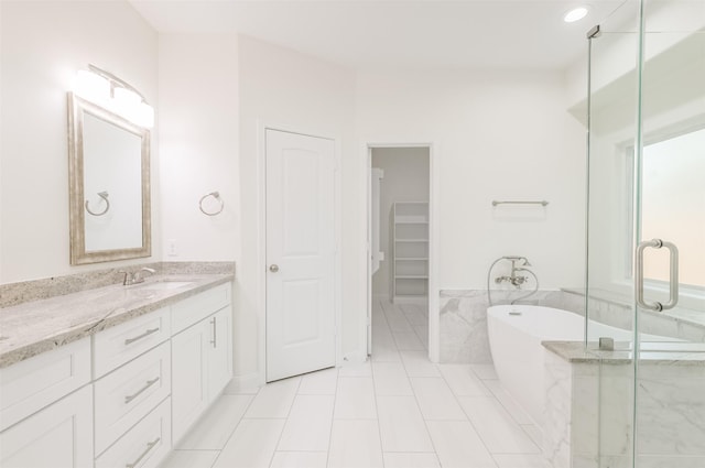 10618 Bassoon Dr, Houston, TX 77025 - bathroom featuring vanity, a soaking tub, a shower stall, a spacious closet, and tile patterned floors