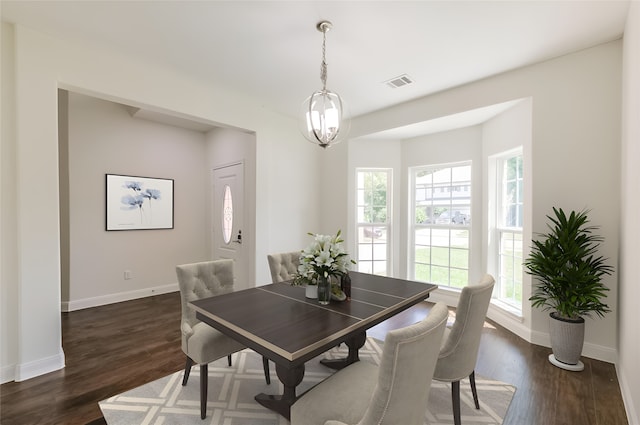 10618 Bassoon Dr, Houston, TX 77025 - dining room with baseboards, dark wood-type flooring, and a chandelier