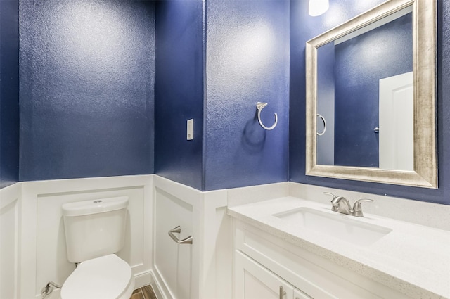10618 Bassoon Dr, Houston, TX 77025 - half bathroom featuring toilet, vanity, and a textured wall
