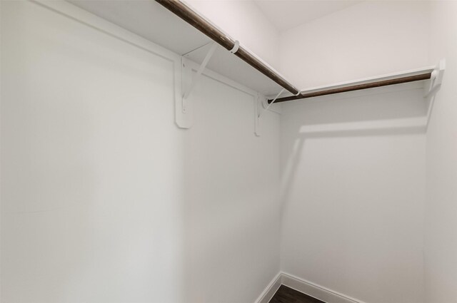 10618 Bassoon Dr, Houston, TX 77025 - walk in closet with dark wood-style floors