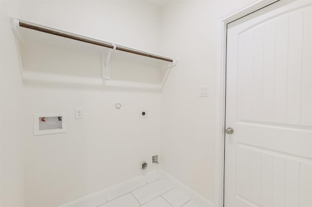 10618 Bassoon Dr, Houston, TX 77025 - laundry area featuring electric dryer hookup, washer hookup, gas dryer hookup, light tile patterned floors, and baseboards