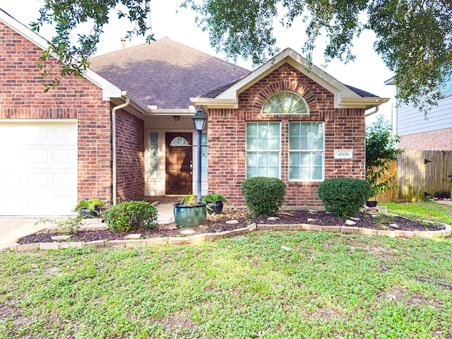 4906 Arbor Falls Ln, Houston, TX 77084 - ranch-style house with brick siding, an attached garage, and roof with shingles