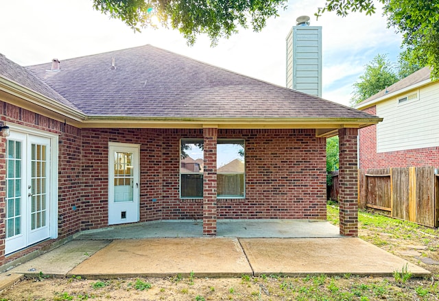 4906 Arbor Falls Ln, Houston, TX 77084 - rear view of house featuring roof with shingles, a chimney, and brick siding