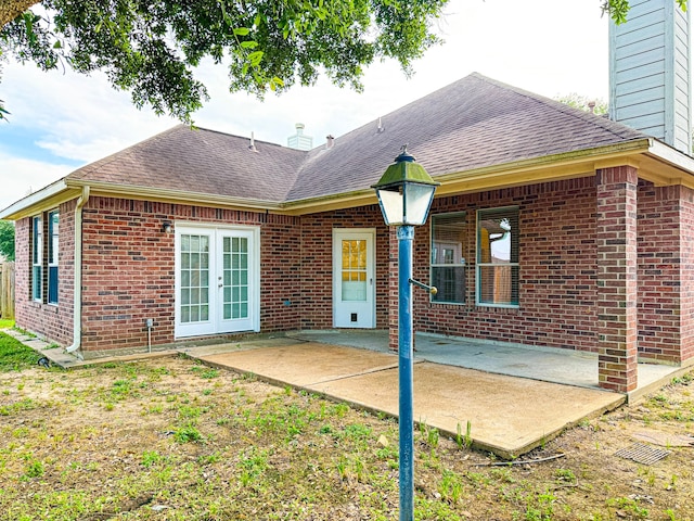 4906 Arbor Falls Ln, Houston, TX 77084 - rear view of house with a shingled roof, a patio area, and brick siding