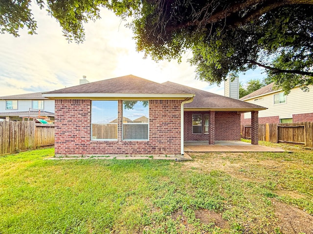 4906 Arbor Falls Ln, Houston, TX 77084 - rear view of house featuring a patio, brick siding, a chimney, and roof with shingles