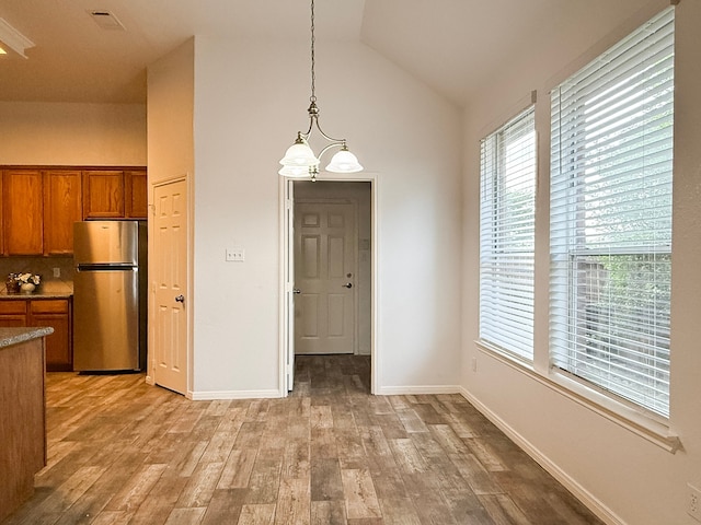 4906 Arbor Falls Ln, Houston, TX 77084 - unfurnished dining area with light wood-style floors, high vaulted ceiling, healthy amount of natural light, and baseboards