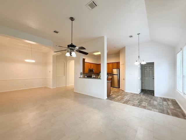 4906 Arbor Falls Ln, Houston, TX 77084 - unfurnished living room featuring a ceiling fan, vaulted ceiling, arched walkways, and baseboards