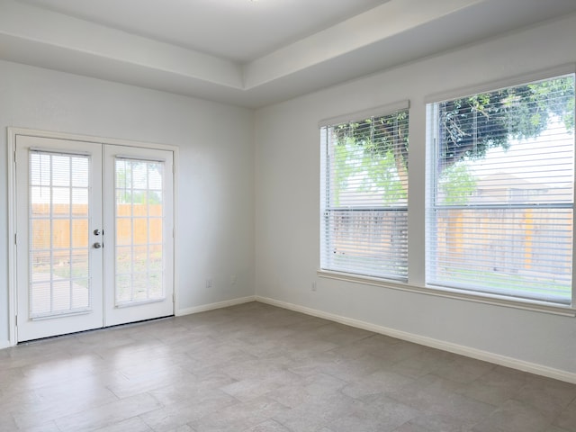 4906 Arbor Falls Ln, Houston, TX 77084 - spare room featuring french doors, baseboards, and a raised ceiling