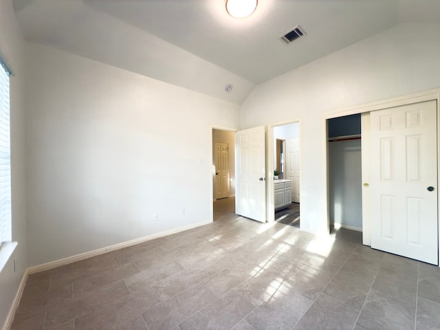 4906 Arbor Falls Ln, Houston, TX 77084 - unfurnished bedroom featuring lofted ceiling, a closet, baseboards, and ensuite bath