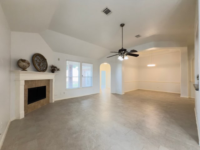 4906 Arbor Falls Ln, Houston, TX 77084 - unfurnished living room featuring a ceiling fan, arched walkways, a tile fireplace, vaulted ceiling, and baseboards