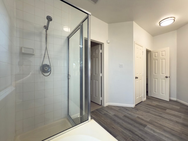 4906 Arbor Falls Ln, Houston, TX 77084 - bathroom with a shower stall, wood finished floors, and baseboards