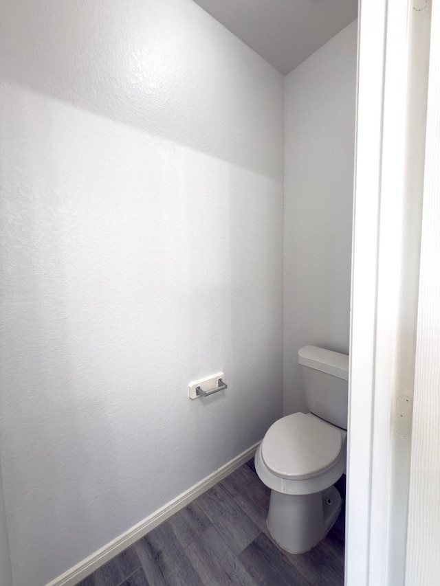 4906 Arbor Falls Ln, Houston, TX 77084 - bathroom with wood finished floors, toilet, and baseboards