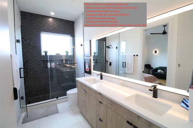 113 E 32nd St Unit A, Houston, TX 77018 - ensuite bathroom with double vanity, a shower stall, tile patterned flooring, a ceiling fan, and toilet